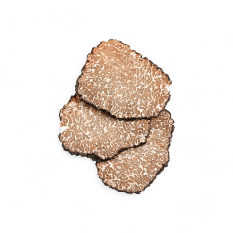 Freeze dried black truffle slice from Terra Ross Truffle Delights on textured surface